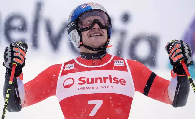 Switzerland's Marco Odermatt celebrates winning an alpine ski, men's World Cup giant slalom, in Adelboden, Switzerland, Saturday, Jan. 10, 2026. (AP Photo/Giovanni Zenoni)