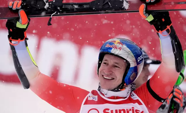 Switzerland's Marco Odermatt celebrates winning an alpine ski, men's World Cup giant slalom, in Adelboden, Switzerland, Saturday, Jan. 10, 2026. (AP Photo/Giovanni Zenoni)