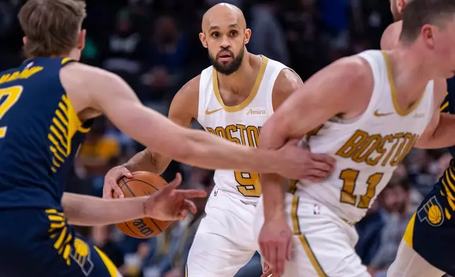 Boston Celtics guard Derrick White (9) looks to pass the ball during the second half of an NBA basketball game against the Indiana Pacers in Indianapolis, Monday, Jan. 12, 2026. (AP Photo/Doug McSchooler)