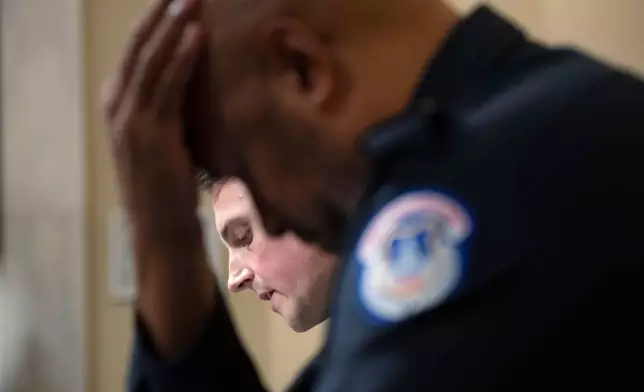 FILE - U.S. Capitol Police Sgt. Harry Dunn listens as Washington Metropolitan Police Department officer Daniel Hodges testifies before the House select committee hearing on the Jan. 6 attack on Capitol Hill in Washington, July 27, 2021. (Brendan Smialowski/Pool via AP, File)