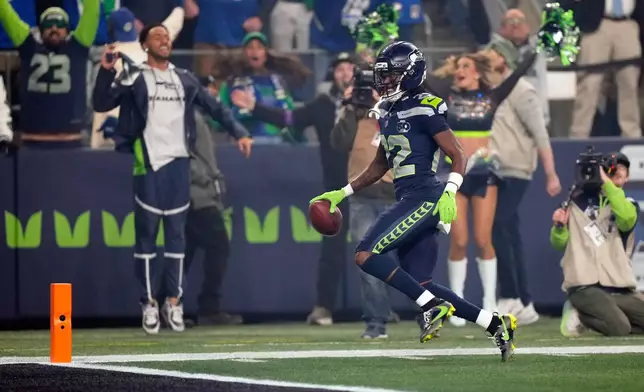 Seattle Seahawks wide receiver Rashid Shaheed (22) runs a kickoff return in for a touchdown during the first half of an NFL football divisional playoff game against the San Francisco 49ers, Saturday, Jan. 17, 2026, in Seattle. (AP Photo/Stephen Brashear)