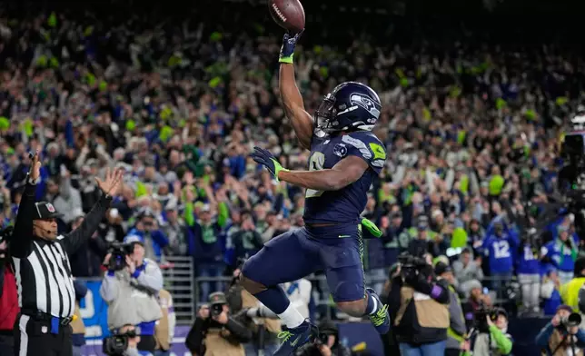 Seattle Seahawks running back Kenneth Walker III (9) celebrates after scoring a touchdown during the second half of an NFL football divisional playoff game against the San Francisco 49ers, Saturday, Jan. 17, 2026, in Seattle. (AP Photo/Stephen Brashear)
