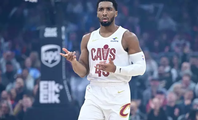 Cleveland Cavaliers guard Donovan Mitchell celebrates after making a three-point basket in the first half of an NBA basketball game against the Sacramento Kings, Friday, Jan. 23, 2026, in Cleveland. (AP Photo/David Dermer)
