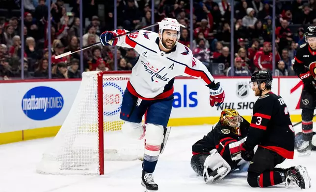 Washington Capitals' Tom Wilson (43) celebrates his goal on Ottawa Senators goalie Leevi Merilainen (1) during first period NHL hockey action on New Year's Day in Ottawa, on Thursday, Jan. 1, 2026. (Spencer Colby/The Canadian Press via AP)