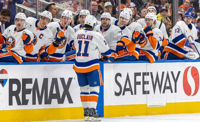 New York Islanders' Anthony Duclair (11) celebrates with his teammates at the bench after a goal against the Edmonton Oilers during the third period of an NHL hockey game in Edmonton, Alberta, Thursday, Jan. 15, 2026. (Timothy Matwey/The Canadian Press via AP)