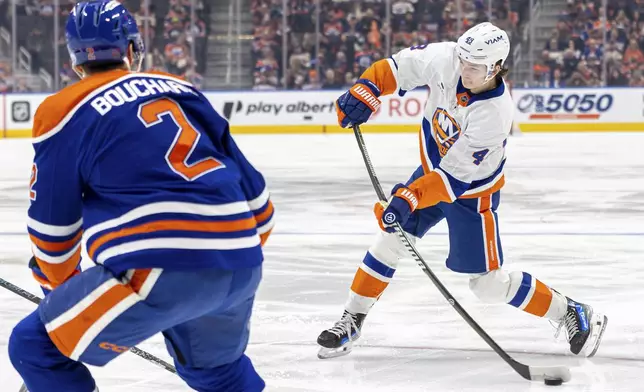 New York Islanders' Matthew Schaefer (48) takes a shot on net against the Edmonton Oilers during the first period of an NHL hockey game in Edmonton, Alberta, Thursday, Jan. 15, 2026. (Timothy Matwey/The Canadian Press via AP)