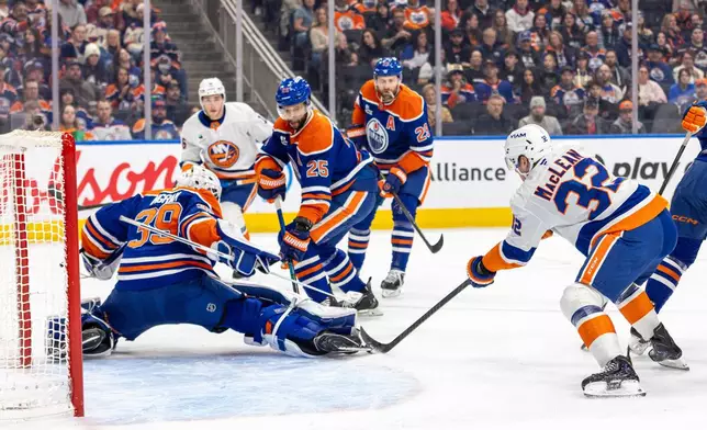 Edmonton Oilers goalie Connor Ingram (39) makes a save against New York Islanders' Kyle MacLean (32) during the first period of an NHL hockey game in Edmonton, Alberta, Thursday, Jan. 15, 2026. (Timothy Matwey/The Canadian Press via AP)