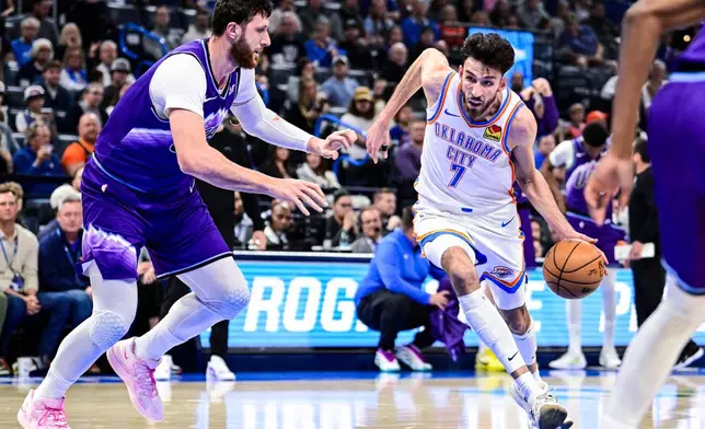 Oklahoma City Thunder center/forward Chet Holmgren (7) drives against Utah Jazz center Jusuf Nurkić (30) during the first half of an NBA basketball game, Wednesday, Jan. 7, 2025, in Oklahoma City. (AP Photo/Gerald Leong)