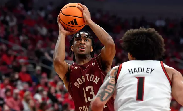 Boston College guard Donald Hand Jr. (13) shoots over Louisville guard J'vonne Hadley (1) during the first half of an NCAA college basketball game in Louisville, Ky., Saturday, Jan. 10, 2026. (AP Photo/Timothy D. Easley)