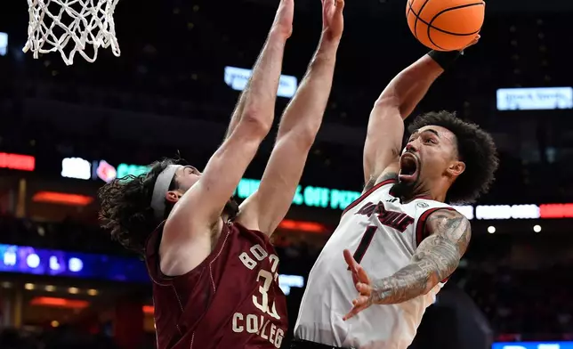 Louisville guard J'vonne Hadley (1) goes in for a dunk against Boston College center Boden Kapke (33) during the second half of an NCAA college basketball game in Louisville, Ky., Saturday, Jan. 10, 2026. (AP Photo/Timothy D. Easley)