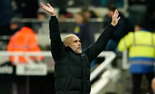 Manchester City's head coach Pep Guardiola applauds fans at the end of the English League Cup semifinal first leg soccer match between Newcastle and Manchester City in Newcastle, England, Wednesday, Jan. 14, 2026. (AP Photo/Dave Thompson)