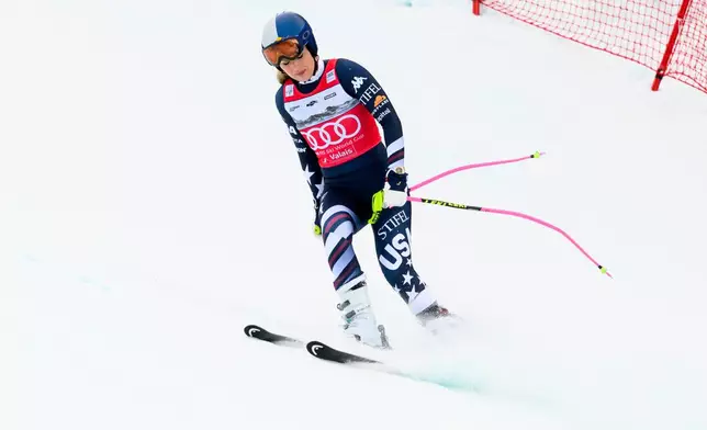 United States' Lindsey Vonn approaches the finish area after crashing, during an alpine ski, women’s World Cup downhill, in Crans Montana, Switzerland, Friday, Jan. 30, 2026. (Jean-Christophe Bott/Keystone via AP)
