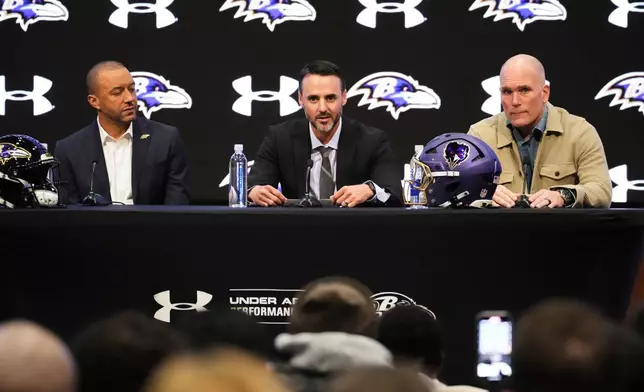 Baltimore Ravens head coach Jesse Minter, center, speaks during an introductory press conference with Ravens president Sashi Brown, left, and executive vice president and general manager Eric DeCosta, at the Under Armour Performance Center in Owings Mills, Md., Thursday, Jan. 29, 2026. (AP Photo/Stephanie Scarbrough)
