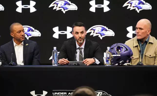 Baltimore Ravens head coach Jesse Minter, center, speaks during an introductory press conference with Ravens president Sashi Brown, left, and executive vice president and general manager Eric DeCosta, at the Under Armour Performance Center in Owings Mills, Md., Thursday, Jan. 29, 2026. (AP Photo/Stephanie Scarbrough)