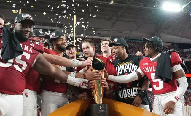 Indiana head coach Curt Cignetti holds the trophy after their win against Miami in the College Football Playoff national championship game, Monday, Jan. 19, 2026, in Miami Gardens, Fla. (AP Photo/Rebecca Blackwell)