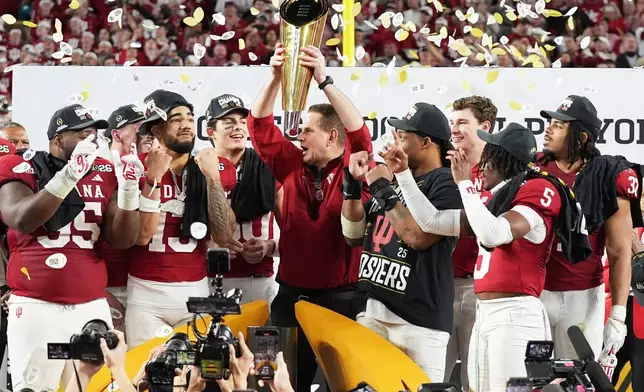 Indiana head coach Curt Cignetti holds the trophy after their win against Miami in the College Football Playoff national championship game, Monday, Jan. 19, 2026, in Miami Gardens, Fla. (AP Photo/Lynne Sladky)