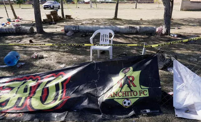 Crime scene tape surrounds a soccer field the day after gunmen opened fire, killing and wounding people, in Salamanca, Mexico, Monday, Jan. 26, 2026. (AP Photo/Mario Armas)