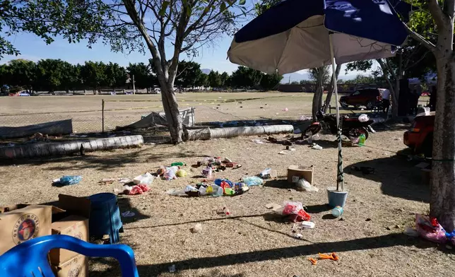 People's items left behind cover the ground at a soccer field the day after gunmen opened fire, killing and wounding people, in Salamanca, Mexico, Monday, Jan. 26, 2026. (AP Photo/Mario Armas)