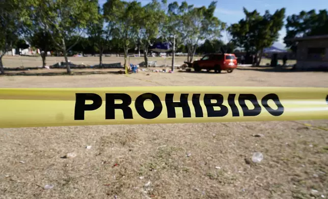 Crime scene tape surrounds a soccer field the day after gunmen opened fire, killing and wounding people, in Salamanca, Mexico, Monday, Jan. 26, 2026. (AP Photo/Mario Armas)