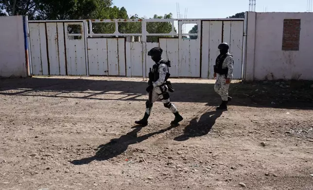 National Guards patrol near a soccer field the day after gunmen opened fire, killing and wounding people, in Salamanca, Mexico, Monday, Jan. 26, 2026. (AP Photo/Mario Armas)