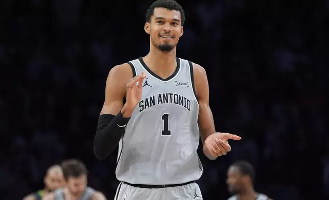 San Antonio Spurs forward Victor Wembanyama reacts after missing a shot during the second half of an NBA basketball game against the Minnesota Timberwolves, Sunday, Jan. 11, 2026, in Minneapolis. (AP Photo/Abbie Parr)