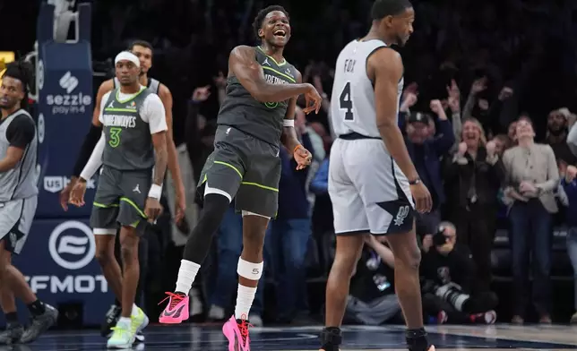 Minnesota Timberwolves guard Anthony Edwards, center, celebrates as time in an NBA basketball game against the San Antonio Spurs, Sunday, Jan. 11, 2026, in Minneapolis. (AP Photo/Abbie Parr)