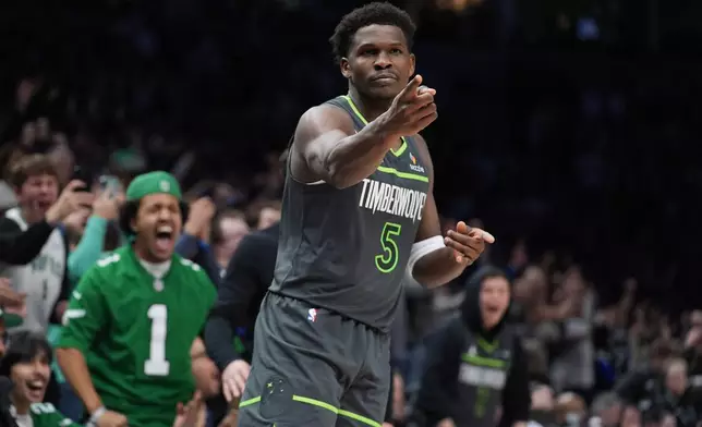 Minnesota Timberwolves guard Anthony Edwards (5) reacts after making a basket during the second half of an NBA basketball game against the San Antonio Spurs, Sunday, Jan. 11, 2026, in Minneapolis. (AP Photo/Abbie Parr)