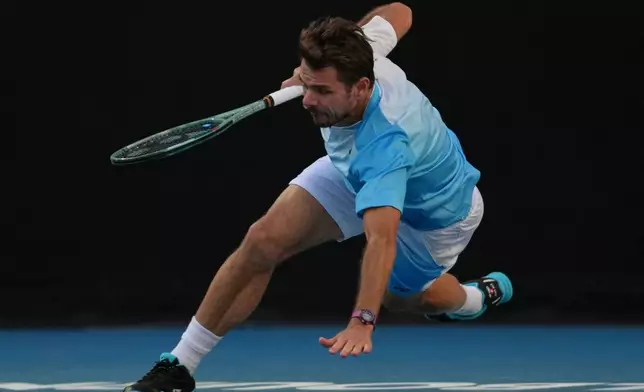 Stan Wawrinka of Switzerland falls during his second round match against Arthur Gea of France at the Australian Open tennis championship in Melbourne, Australia, Thursday, Jan. 22, 2026. (AP Photo/Dita Alangkara)