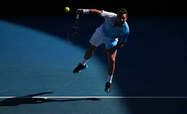 Stan Wawrinka of Switzerland serves to Arthur Gea of France at the Australian Open tennis championship in Melbourne, Australia, Thursday, Jan. 22, 2026. (AP Photo/Dita Alangkara)