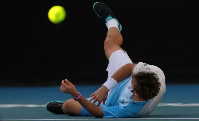 Stan Wawrinka of Switzerland falls during his second round match against Arthur Gea of France at the Australian Open tennis championship in Melbourne, Australia, Thursday, Jan. 22, 2026. (AP Photo/Dita Alangkara)