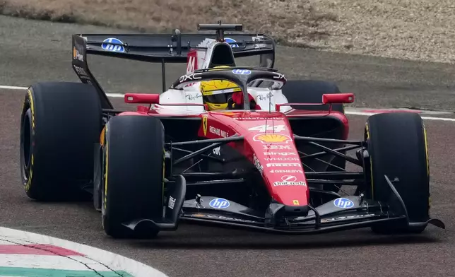 Britain's Lewis Hamilton steers his Ferrari Formula One SF-26 at the Ferrari private test track, in Fiorano Modenese, Italy, Friday, Jan. 23, 2026. (AP Photo/Antonio Calanni)
