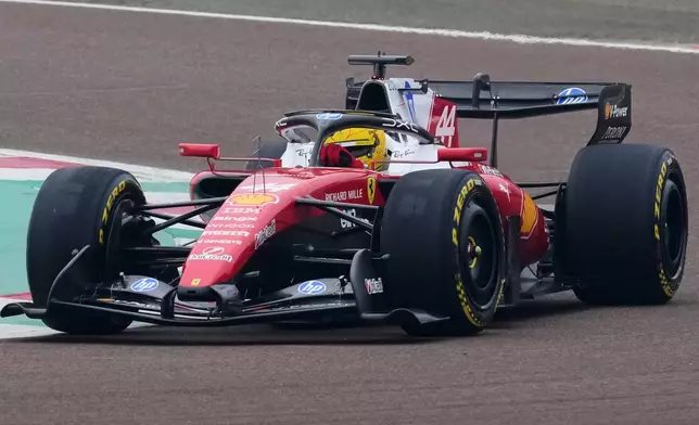 Britain's Lewis Hamilton steers his Ferrari Formula One SF-26 at the Ferrari private test track, in Fiorano Modenese, Italy, Friday, Jan. 23, 2026. (AP Photo/Antonio Calanni)