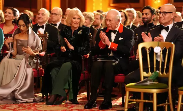 Britain's King Charles III and Queen Camilla attend the premiere of Prime Video's Finding Harmony: A King's Vision, at Windsor Castle in Berkshire, England, Wednesday, Jan. 28, 2026. (Jonathan Brady/Pool Photo via AP)