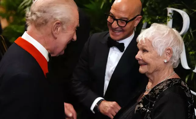 Britain's King Charles III speaks to Stanley Tucci and Judi Dench in the Grand Reception Room after they attended the premiere of Prime Video's Finding Harmony: A King's Vision, at Windsor Castle in Berkshire, England, Wednesday, Jan. 28, 2026. (Jonathan Brady/Pool Photo via AP)