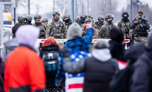 Federal agents and police clash with protesters outside the Bishop Henry Whipple Federal Building, in Minneapolis, Minn., on Thursday, Jan. 8, 2026. (Christopher Katsarov/The Canadian Press via AP)