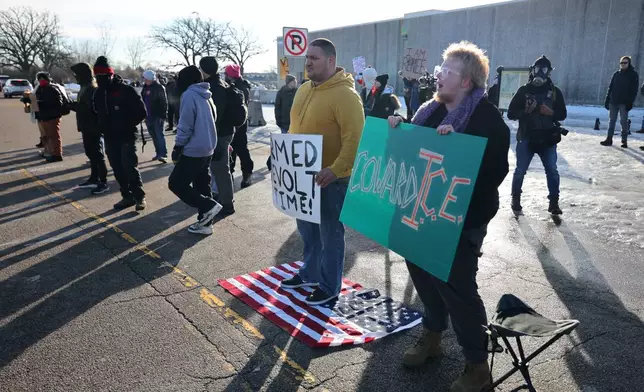 Protesters gather across the street from the Bishop Henry Whipple Federal Building as protesters gather in Minneapolis, Friday, Jan. 9, 2026.(AP Photo/Adam Bettcher)