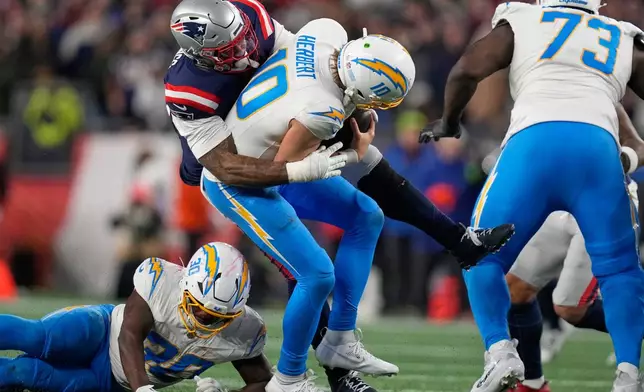 New England Patriots linebacker Anfernee Jennings sacks Los Angeles Chargers quarterback Justin Herbert (10) in the second half of an NFL wild-card playoff football game in Foxborough, Mass., Sunday, Jan. 11, 2026. (AP Photo/Charles Krupa)