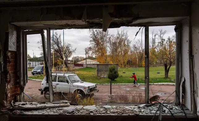 A young biathlete trains outside the destroyed ski base in Chernihiv, Ukraine, Thursday, Oct. 30, 2025. (AP Photo/Julia Demaree Nikhinson)