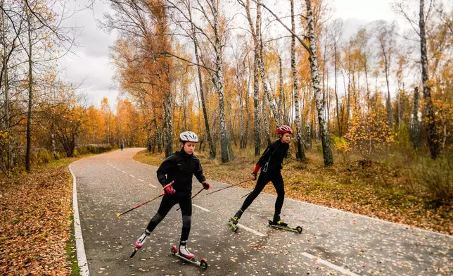 Biathletes Mykola Dorofeiev, 16, and Nazar Kravchenko, 12, left, train at the ski base in Chernihiv, Ukraine, Thursday, Oct. 30, 2025. (AP Photo/Julia Demaree Nikhinson)