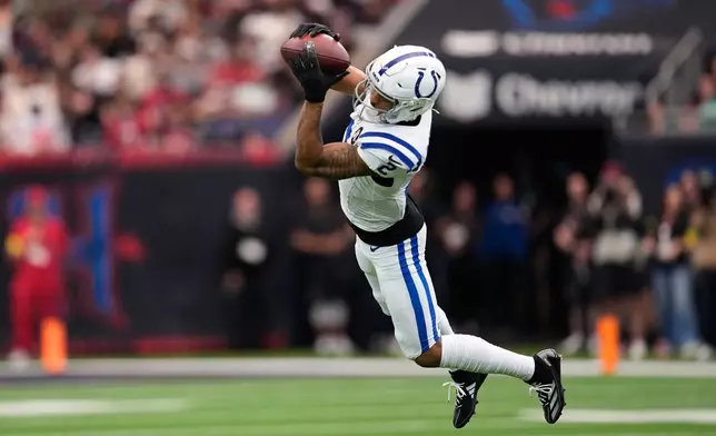 Indianapolis Colts wide receiver Josh Downs (2) makes a catch for first down against the Houston Texans during the first half of an NFL football game in Houston, Sunday, Jan. 4, 2026. (AP Photo/David J. Phillip)