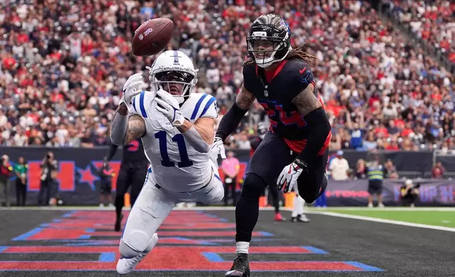 Indianapolis Colts wide receiver Michael Pittman Jr. (11) fails to make a catch in front of Houston Texans cornerback Derek Stingley Jr. (24) during the first half of an NFL football game in Houston, Sunday, Jan. 4, 2026. (AP Photo/Ashley Landis)