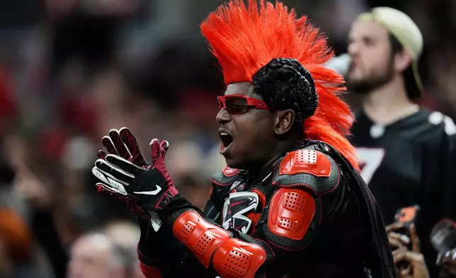 An Atlanta Falcons fan cheers in the second half of an NFL football game against the Los Angeles Rams, Monday, Dec. 29, 2025, in Atlanta. (AP Photo/Mike Stewart)