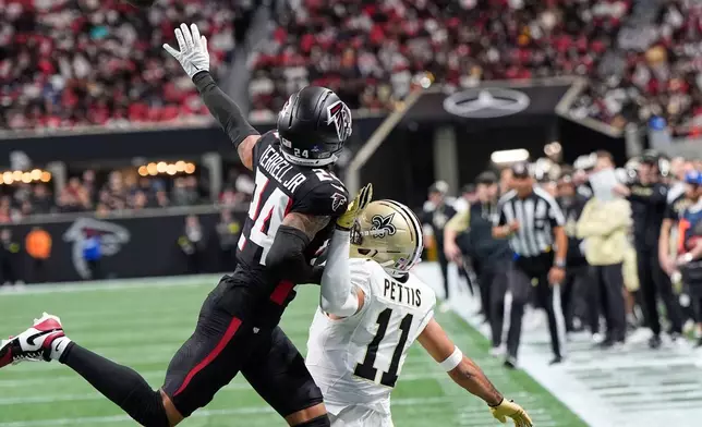Atlanta Falcons cornerback A.J. Terrell Jr. (24) commits pass interference near the goal line against New Orleans Saints wide receiver Dante Pettis (11) in the first half of an NFL football game, Sunday, Jan. 4, 2026, in Atlanta. (AP Photo/Brynn Anderson)