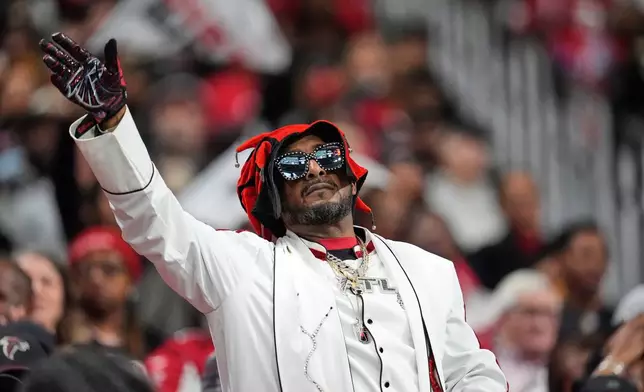An Atlanta Falcons fan celebrates in the first half of an NFL football game against the New Orleans Saints, Sunday, Jan. 4, 2026, in Atlanta. (AP Photo/Mike Stewart)