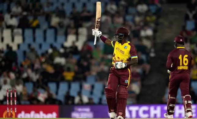 West Indies batsman Sherfane Rutherford raises his bat after reaching a half century during the T20 International cricket match between South Africa and West Indies, in Centurion, South Africa, Thursday, Jan. 29, 2026. (AP Photo/Themba Hadebe)