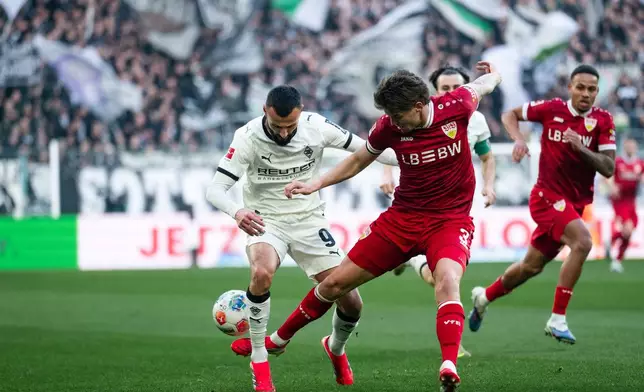 Stuttgart's Ramon Hendriks, right, and Mönchengladbach's Franck Honorat in action during the Bundesliga soccer match between Borussia Mönchengladbach and VfB Stuttgart in Mönchengladbach, Germany, Sunday Jan. 25, 2026. (Marius Becker/dpa via AP)