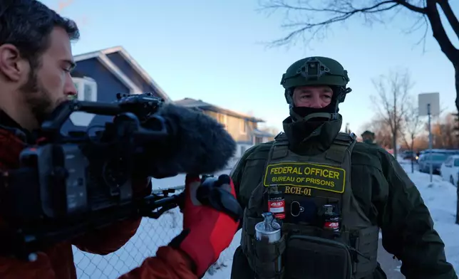 ADDS MORE INFORMATION Federal Bureau of Prisons officers threaten AP video journalist Mark Vancleave with arrest on Wednesday, Jan. 28, 2026, in Minneapolis. (AP Photo/Julia Demaree Nikhinson)
