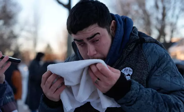A person is attended to after federal officers used a chemical irritant on Wednesday, Jan. 28, 2026, in Minneapolis. (AP Photo/Julia Demaree Nikhinson)