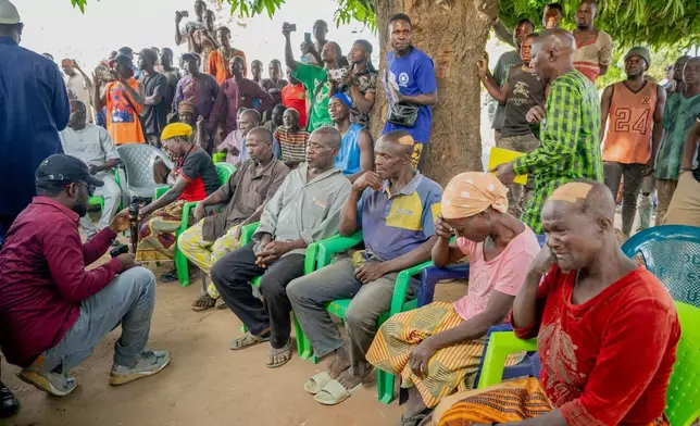 In this photo released by the Kaduna State government, people react during a meeting with Kaduna state Governor. Uba Sani, after gunmen attack in Kurmin Wali, northwest Nigeria, Wednesday, Jan. 21, 2026. (Kaduna State Government via AP)
