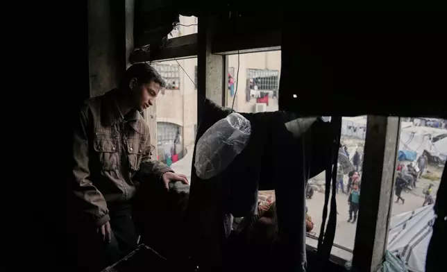 Mahmoud Abu Ishaq, 14, who is suffering vision loss and is awaiting permission to travel outside the Gaza Strip for medical treatment, poses for a photo in Khan Younis, Gaza Strip, Tuesday, Jan. 27, 2026. (AP Photo/Abdel Kareem Hana)